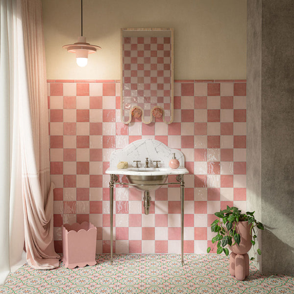 Bathroom featuring Zellige Pink Mist Square 13.2x13.2cm Moroccan-style wall tiles, arranged in a pink chequerboard pattern alongside rose pink tiles, paired with colourful patterned floor tiles and a marble-effect washbasin.