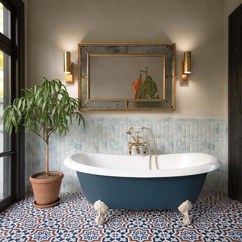 Bathroom featuring Balthazar Grand 20x20cm Victorian Moroccan-style floor tiles with an intricate blue, terracotta and white geometric pattern, paired with a freestanding bath, brass fixtures and traditional detailing for a luxurious statement interior.