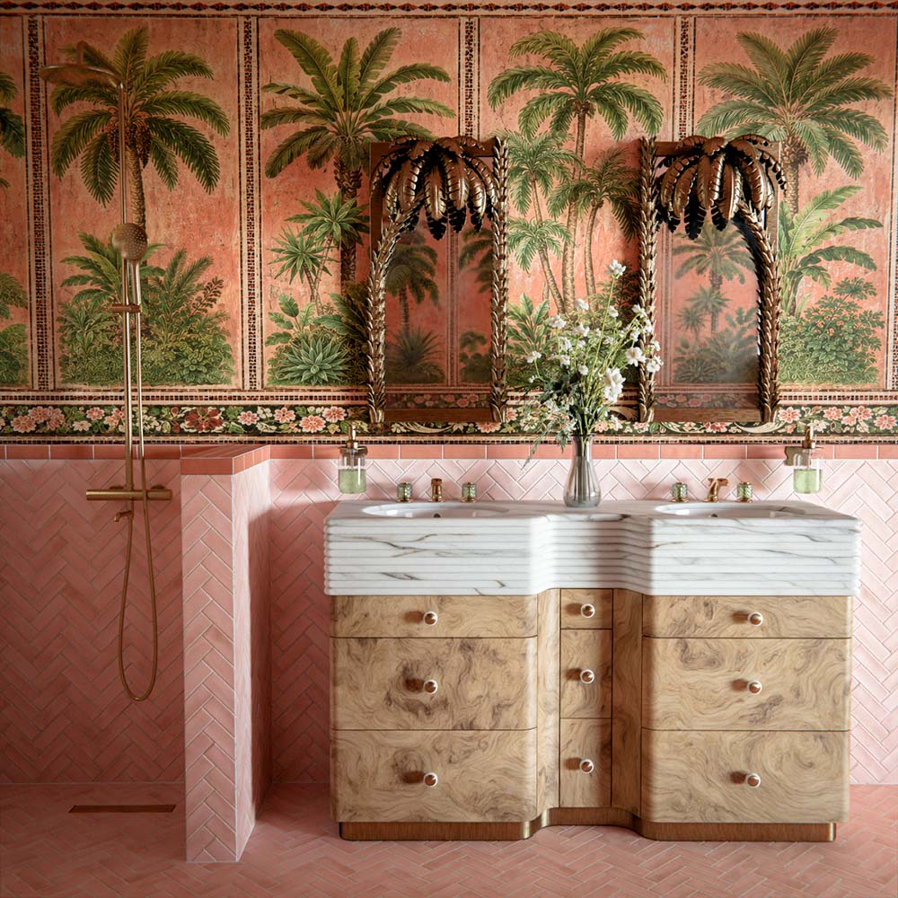 Bathroom vanity area featuring Benomar Moroccan-style brick tiles in soft blush and ivory tones, installed vertically as a statement wall, styled with a fluted pink basin, brushed brass tap, marble surface, and greenery.
