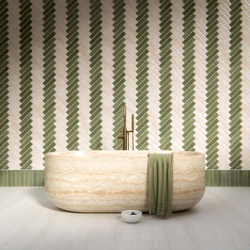 Bathroom interior showcasing the Nomad tile collection, with sage green and oatmeal brick tiles in a herringbone layout, creating a calm, textural backdrop paired with natural stone and warm, contemporary styling.