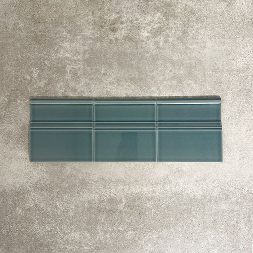 Pimlico River Blue 15 × 15cm ceramic skirting tiles with a crackle glaze finish, featuring rich blue tones and moulded detailing, designed to create a neat transition between tiled walls and floors.