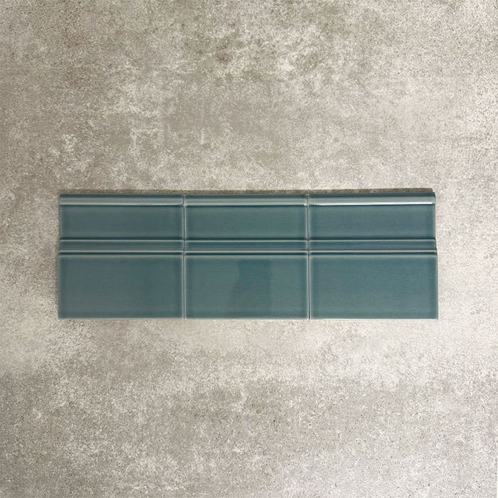 Pimlico River Blue 15 × 15cm ceramic skirting tiles with a crackle glaze finish, featuring rich blue tones and moulded detailing, designed to create a neat transition between tiled walls and floors.