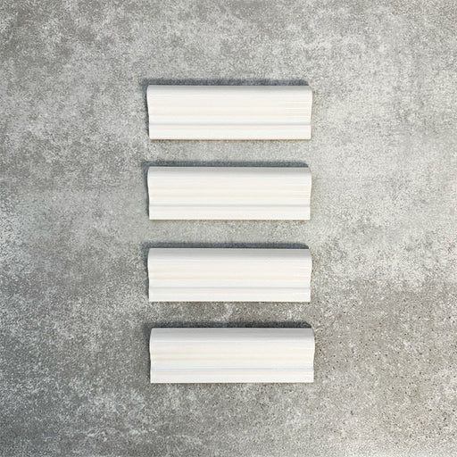 Pimlico White dado trim tiles measuring 5 × 15cm, finished with a crackle glaze and soft white tone, designed to add a decorative feature line and classic detail to ceramic wall tile layouts.