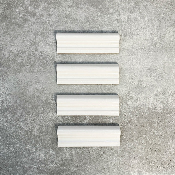 Pimlico White dado trim tiles measuring 5 × 15cm, finished with a crackle glaze and soft white tone, designed to add a decorative feature line and classic detail to ceramic wall tile layouts.