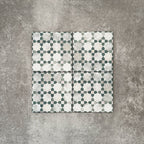 Four Berber Mequinez Green 15×15cm Moroccan-style porcelain tiles arranged together, highlighting the soft green and cream geometric pattern on a neutral background.