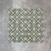 Cuba Fleur de Lis Moroccan-style porcelain tiles in a 20×20cm square format, arranged in a repeating decorative pattern featuring soft green and white detailing, and classic encaustic-style design.