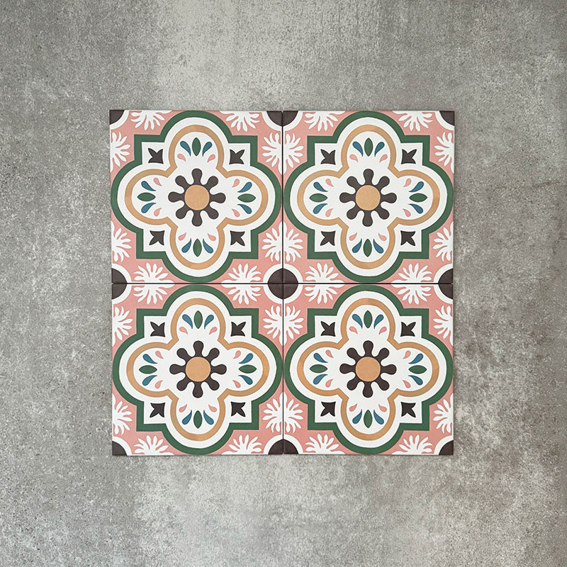 Cuba Paradise Moroccan-style porcelain tiles in a 20×20cm square format, arranged in a repeating floral pattern with coral pink backgrounds, green detailing and white and brown accents, showcasing the tile’s bold symmetry and decorative encaustic-style design.