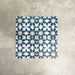 Souk Blue C 20×20cm Moroccan-style porcelain tiles arranged in a blue, white and grey geometric pattern.