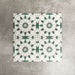 Souk Green A 20×20cm Moroccan-style porcelain tiles arranged in a green, white and beige geometric pattern.