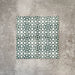 Four Berber Tetuan Green 15×15cm Moroccan-style porcelain tiles arranged together, highlighting the green and cream geometric pattern on a neutral background.