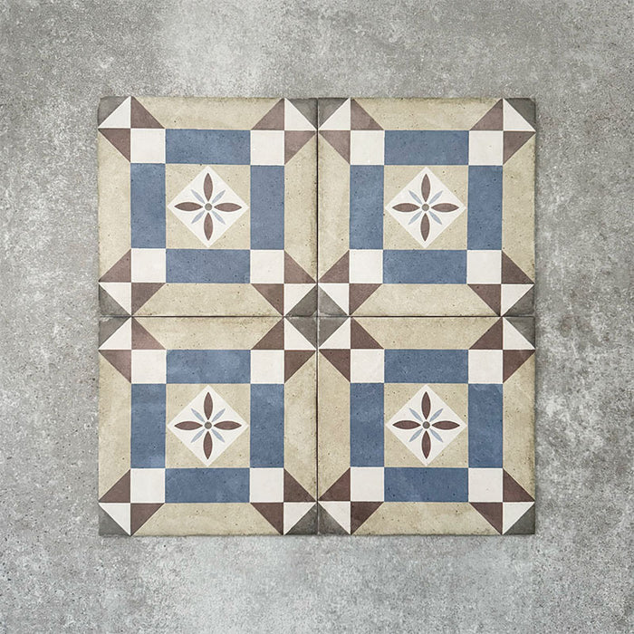Viscount Harley Street 20×20cm Victorian-style porcelain wall and floor tiles laid in a repeating geometric square pattern with a central floral motif in soft blue, beige, warm grey and white tones, shown as a full tile layout with subtle tonal variation and floral styling.