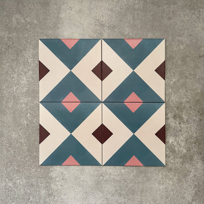 Cuba Guazzatto Moroccan-style porcelain tiles in a 20×20cm square format, shown in a four-tile layout to display the repeating geometric diamond pattern in soft blue, white, pink and burgundy tones, highlighting the tile’s clean lines and contemporary encaustic-style design.