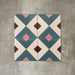 Cuba Guazzatto Moroccan-style porcelain tiles in a 20×20cm square format, shown in a four-tile layout to display the repeating geometric diamond pattern in soft blue, white, pink and burgundy tones, highlighting the tile’s clean lines and contemporary encaustic-style design.
