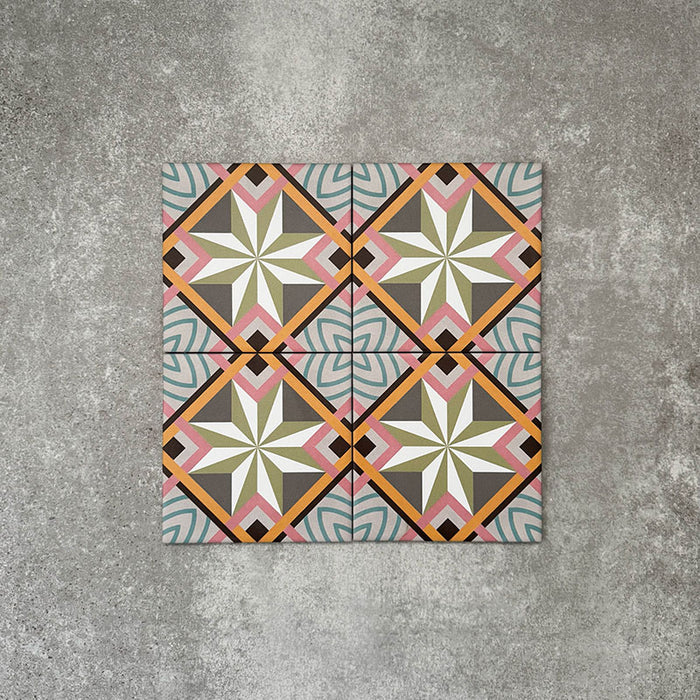 Cuba Star Mini Moroccan-style porcelain tiles in a 15×15cm square format, arranged in a repeating geometric star pattern with soft green, blue, pink and mustard tones, highlighting the tile’s crisp symmetry, fine detailing and decorative encaustic-style design.