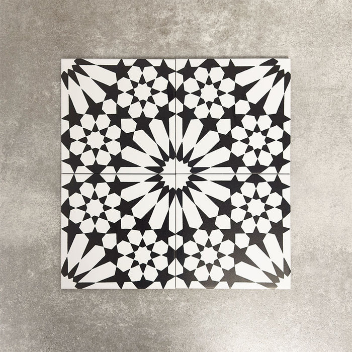 Fez Winter Moroccan-style porcelain tiles arranged as a four-tile pattern, forming a striking central star motif. The 20 × 20cm tiles feature a bold black and white geometric design with crisp lines and high contrast, showcasing the full encaustic-effect pattern when laid together. Ideal for statement floors, feature walls, and contemporary or monochrome interiors.