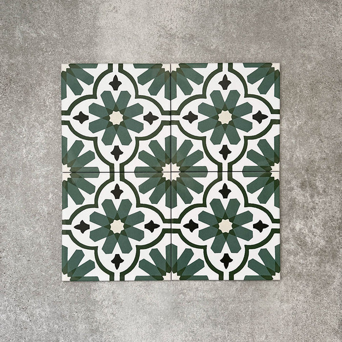 Clara Verde Victorian Moroccan-style porcelain floor tiles in a 20 × 20cm format, laid in a repeating pattern to highlight the bold green geometric design with decorative styling accents.