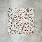 Turin Terrazzo Blanco Drops porcelain tile in a 20 × 20cm format, featuring a terrazzo-style design with larger scattered stone fragments in warm neutral tones on a light base, shown on a neutral background to highlight the texture and pattern suitable for wall and floor use.