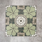 Nantes Green Moroccan-style tiles in a 20x20cm format, shown as a full pattern layout. The design features soft green floral motifs combined with circular mosaic-style detailing and neutral stone-effect tones, creating a balanced, decorative floor or wall tile pattern inspired by traditional Moroccan designs.