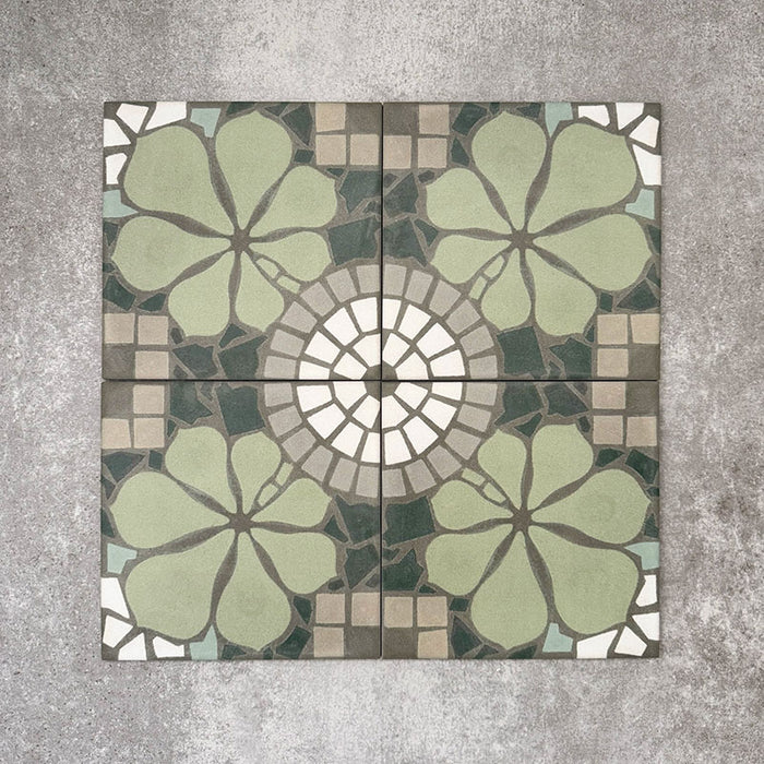 Nantes Green Moroccan-style tiles in a 20x20cm format, shown as a full pattern layout. The design features soft green floral motifs combined with circular mosaic-style detailing and neutral stone-effect tones, creating a balanced, decorative floor or wall tile pattern inspired by traditional Moroccan designs.