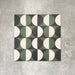 Abstract Circles Patterned Tiles in a 20x20cm format, shown in a repeating grid layout to highlight the bold circular design. Deep green, charcoal and soft cream tones create a striking yet balanced pattern, styled with floral accents to showcase the tiles as a decorative feature suitable for floors, walls or splashbacks.