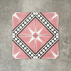 Gilgamesh Pink Moroccan style 20x20cm patterned tiles, shown as a flat lay to highlight the repeating pink, black and white geometric star pattern.