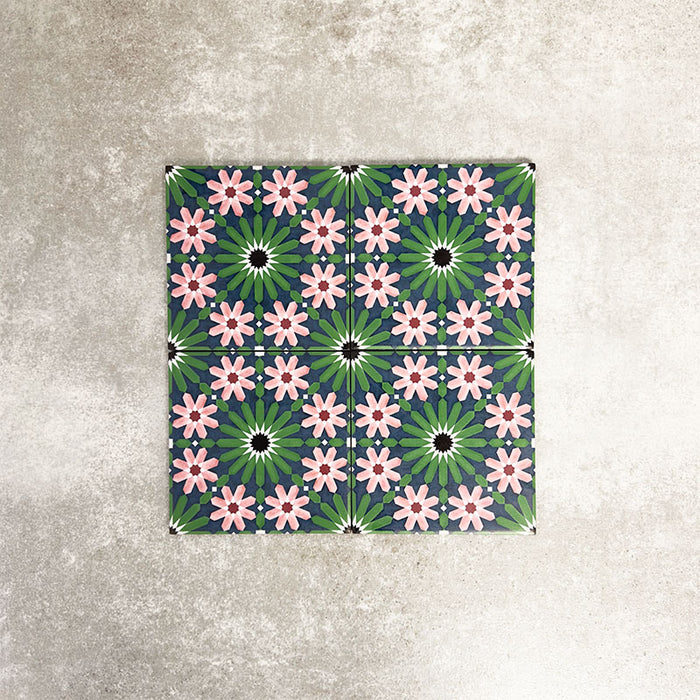 Fez Mini Autumn Moroccan-style porcelain tile shown as a single tile, featuring an intricate geometric star pattern in deep green, soft blush pink, charcoal and white. The 15 × 15cm tile highlights the detailed encaustic-effect design and rich autumnal colour palette, ideal for adding decorative interest to walls or floors.