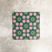 Fez Mini Autumn Moroccan-style porcelain tile shown as a single tile, featuring an intricate geometric star pattern in deep green, soft blush pink, charcoal and white. The 15 × 15cm tile highlights the detailed encaustic-effect design and rich autumnal colour palette, ideal for adding decorative interest to walls or floors.