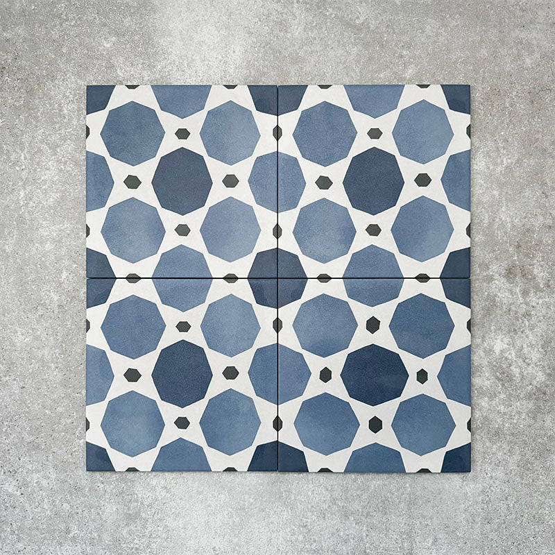 Viscount Sapphire 20×20cm Victorian-style porcelain wall and floor tiles laid in a repeating blue and white geometric pattern, shown as a full tile layout with octagonal motifs and subtle tonal variation, styled with white floral accents.