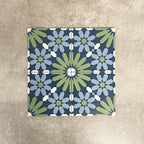 Fez Springs 20x20cm Moroccan-style porcelain tiles arranged as a four-tile panel, highlighting the full repeat design with layered blue and soft green geometric star motifs against a textured grey background.