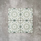 Fez Mini Jade Green 15x15cm Moroccan-style porcelain tile displayed against a textured grey background, highlighting the soft jade green and white geometric star pattern with an encaustic-inspired finish.