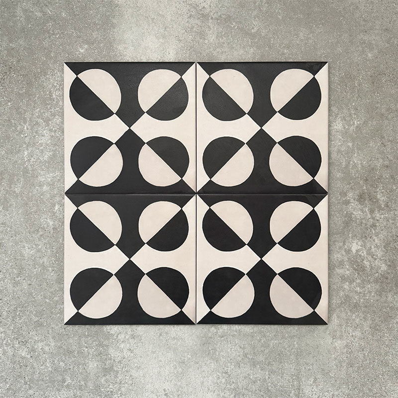 Abstract Illusion Noir Patterned Tiles in a 20x20cm format, displayed in a repeated grid layout to showcase the bold optical illusion design. High-contrast black and soft cream curved shapes create a striking geometric pattern, styled with floral accents to highlight the tiles as a statement choice for feature walls, floors or decorative splashbacks.