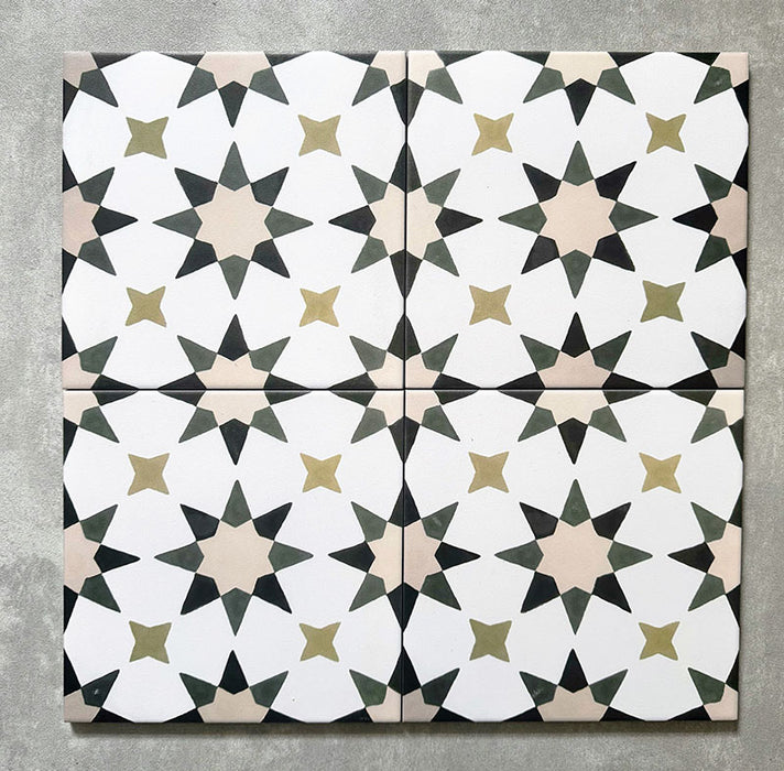 Four Agadir Natural Moroccan-style 20x20cm porcelain tiles laid together, creating a continuous geometric star pattern in soft white with warm beige, olive and charcoal accents.