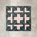 Abstract Lagoon Patterned Tiles in a 20x20cm format, displayed in a repeated grid layout to highlight the bold geometric zigzag design. Deep teal, soft pink and charcoal tones create a striking, contemporary pattern, styled with floral accents to showcase the tiles as a decorative feature suitable for walls, floors or splashbacks.