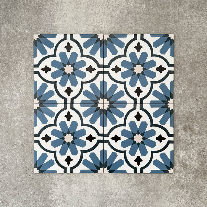 Clara Azul Victorian Moroccan-style porcelain tiles in a 20 × 20cm format, laid in a repeating pattern to showcase the blue and white geometric design across the surface.