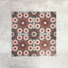 Fez Rosso Moroccan-style porcelain tile, highlighting the intricate geometric pattern in full detail. Deep terracotta and earthy red tones radiate from the centre, layered with soft blush pink star motifs and set against a muted grey background. The balanced, symmetrical design draws inspiration from traditional Moroccan tilework while the porcelain finish keeps it practical and durable. A bold yet elegant choice, ideal for creating feature floors, splashbacks or statement walls with warmth and character.