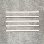 Allegra Blanca Gloss pencil bullnose border ceramic tiles in a 1.2 × 30cm format, shown as a set to highlight the glossy white finish, smooth rounded edges and subtle handmade-style variation for decorative borders and trims.