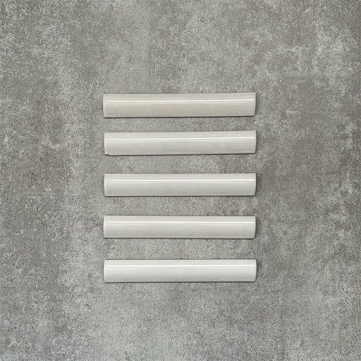 Zellige White bullnose Moroccan-style ceramic tiles in a 3 × 20cm format, shown in a neat row with a smooth, glossy finish.