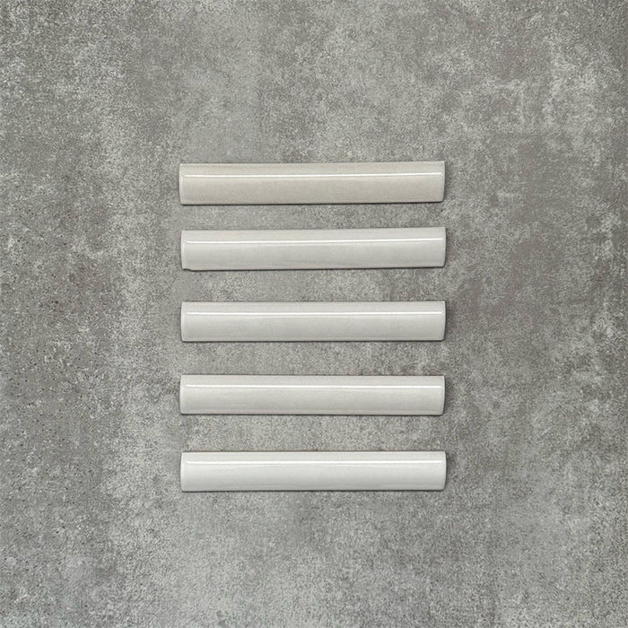 Zellige White bullnose Moroccan-style ceramic tiles in a 3 × 20cm format, shown in a neat row with a smooth, glossy finish.