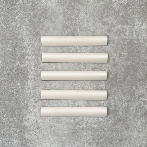 Zellige Oyster bullnose ceramic tiles in a soft oyster white finish, 3 × 20 cm, shown laid flat on a neutral background.
