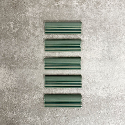 Pimlico Golders Green dado trim tiles measuring 5 × 15cm, finished with a crackle glaze and rich green tone, designed to add a decorative feature line and classic detailing to ceramic wall tile installations.