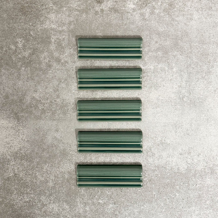 Pimlico Golders Green dado trim tiles measuring 5 × 15cm, finished with a crackle glaze and rich green tone, designed to add a decorative feature line and classic detailing to ceramic wall tile installations.