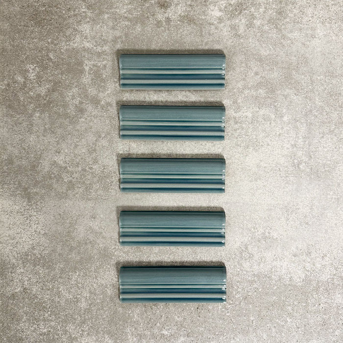 Pimlico River Blue dado trim tiles measuring 5 × 15cm, finished with a crackle glaze and deep blue tone, designed to add a decorative feature line and classic detailing to ceramic wall tile installations.