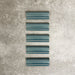 Pimlico River Blue dado trim tiles measuring 5 × 15cm, finished with a crackle glaze and deep blue tone, designed to add a decorative feature line and classic detailing to ceramic wall tile installations.