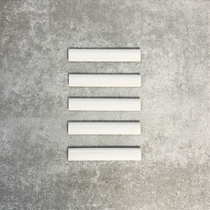 Pimlico White pencil trim tiles measuring 2.5 × 15cm, finished with a crackle glaze and soft white tone, designed to neatly frame ceramic wall tiles and create a clean, decorative edge.