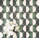 Abstract Circles Patterned Tiles in a 20x20cm format, shown in a repeating grid layout to highlight the bold circular design. Deep green, charcoal and soft cream tones create a striking yet balanced pattern, styled with floral accents to showcase the tiles as a decorative feature suitable for floors, walls or splashbacks.