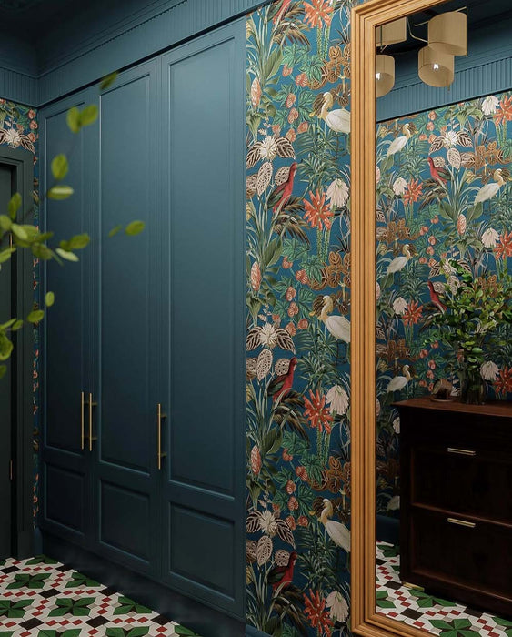 Hallway interior featuring Abstract Compass Green 20x20cm patterned floor tiles in green, white and red tones, styled with teal panelling, botanical wallpaper, wooden console table, and decorative accessories in a characterful entrance space.