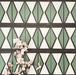 Abstract Hourglass Patterned Tiles in a 20x20cm format, displayed in a repeated grid layout to showcase the bold geometric hourglass design. Muted green and soft cream tones are framed with charcoal detailing, creating a clean, contemporary pattern ideal for feature walls, floors or decorative splashbacks.