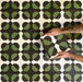 Abstract Illusion Verde Noir Patterned Tiles in a 20x20cm format, displayed in a repeated grid layout to highlight the bold optical illusion design. Deep black and rich green curved shapes create a striking, high-contrast geometric pattern, shown during installation to demonstrate how the design aligns and repeats across floors or feature walls.