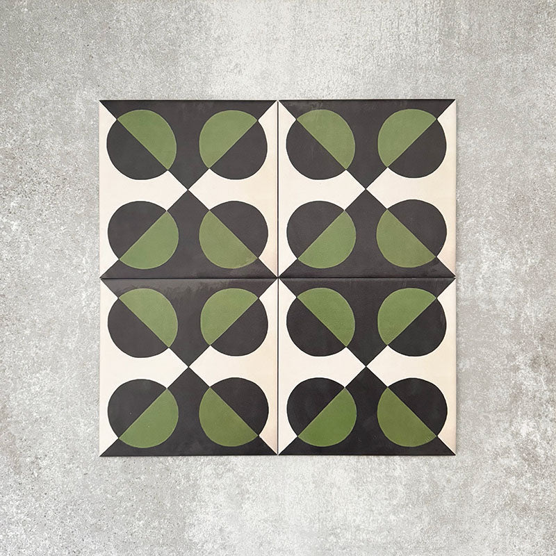 Abstract Illusion Verde Noir Patterned Tiles in a 20x20cm format, displayed in a repeated grid layout to showcase the bold optical illusion design. Deep black and rich green curved shapes contrast with a soft neutral background, creating a striking, high-impact pattern ideal for feature walls, floors or decorative splashbacks.