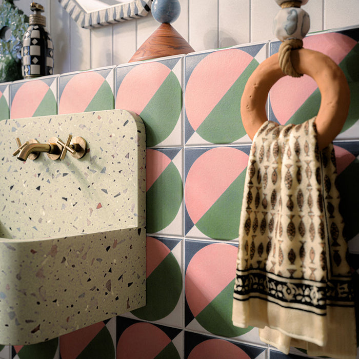 Bathroom featuring Abstract Moon 20x20cm patterned tiles in soft pink and green tones, styled with eclectic décor, statement accessories, and contemporary sanitaryware for a bold playful interior design.